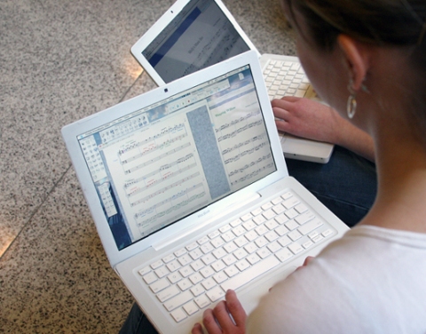 Music students work on their Mac laptops.