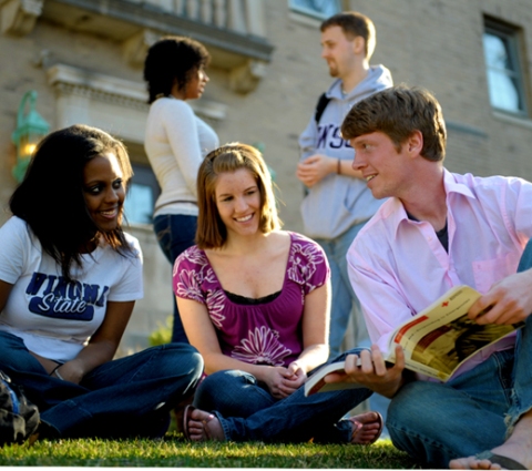Three diversity club students relaxing outside.