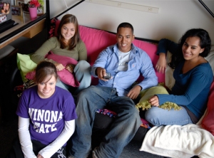 Students hang out in a dorm room.